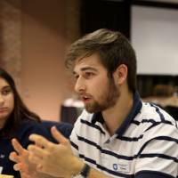 A student shares his perspective at his table discussion